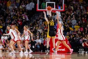 Iowa Hawkeye guard Caitlin Clark (22) makes three point shot against Nebraska Cornhusker guard Callin Hake (14) in the first quarter during a college basketball game on Sunday, February 11, 2024, in Lincoln, Nebraska. Photo by John S. Peterson.