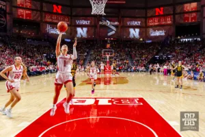 Nebraska Cornhusker guard Jaz Shelley (1) makes a lay up against Iowa Hawkeye guard Kate Martin (20) in the second quarter during a college basketball game on Sunday, February 11, 2024, in Lincoln, Nebraska. Photo by John S. Peterson.