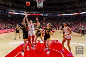 Nebraska Cornhusker guard Logan Nissley (2) reach for a rebound against Iowa Hawkeye guard Sydney Affolter (3) the third quarter during a college basketball game on Sunday, February 11, 2024, in Lincoln, Nebraska. Photo by John S. Peterson.