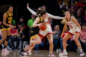 Nebraska Cornhusker guard Kendall Moriarty (15) guards Iowa Hawkeye guard Caitlin Clark (22) closely in the second quarter during a college basketball game on Sunday, February 11, 2024, in Lincoln, Nebraska. Photo by John S. Peterson.
