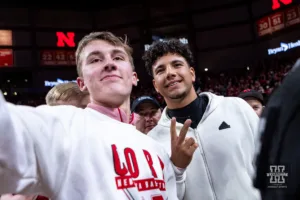 Nebraska Cornhuskers commit Dylan Riaola poses for a selfie with a fan while crashing the court for the win over the Wisconsin Badgers  during a college basketball game on Thursday, February 1, 2024, in Lincoln, Nebraska. Photo by John S. Peterson.