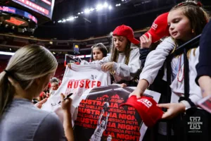 Nebraska Cornhusker guard Allison Weidner (3) signs a t-shirt after a college basketball game against the Minnesota Golden Gophers Saturday, February 24, 2024, in Lincoln, Neb. Photo by John S. Peterson.