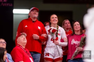 Nebraska Cornhusker senior Maddie Krull (42) watches with her family a vidoe on her after the win over the Minnesota Golden Gophers during a college basketball game Saturday, February 24, 2024, in Lincoln, Neb. Photo by John S. Peterson.