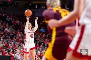 Nebraska Cornhusker guard Maddie Krull (42) makes a three point shot against the Minnesota Golden Gophers during a college basketball game Saturday, February 24, 2024, in Lincoln, Neb. Photo by John S. Peterson.