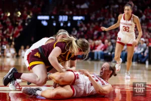 Nebraska Cornhusker guard Callin Hake (14) fights for the ball against Minnesota Golden Gopher guard Grace Grocholski (25) in the second half during a college basketball game Saturday, February 24, 2024, in Lincoln, Neb. Photo by John S. Peterson.