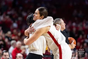 Nebraska Cornhusker forward Annika Stewart (21) gives head coach Amy Williams a hug when coming out of the game against the Minnesota Golden Gophers towards the end of the second half during a college basketball game Saturday, February 24, 2024, in Lincoln, Neb. Photo by John S. Peterson.