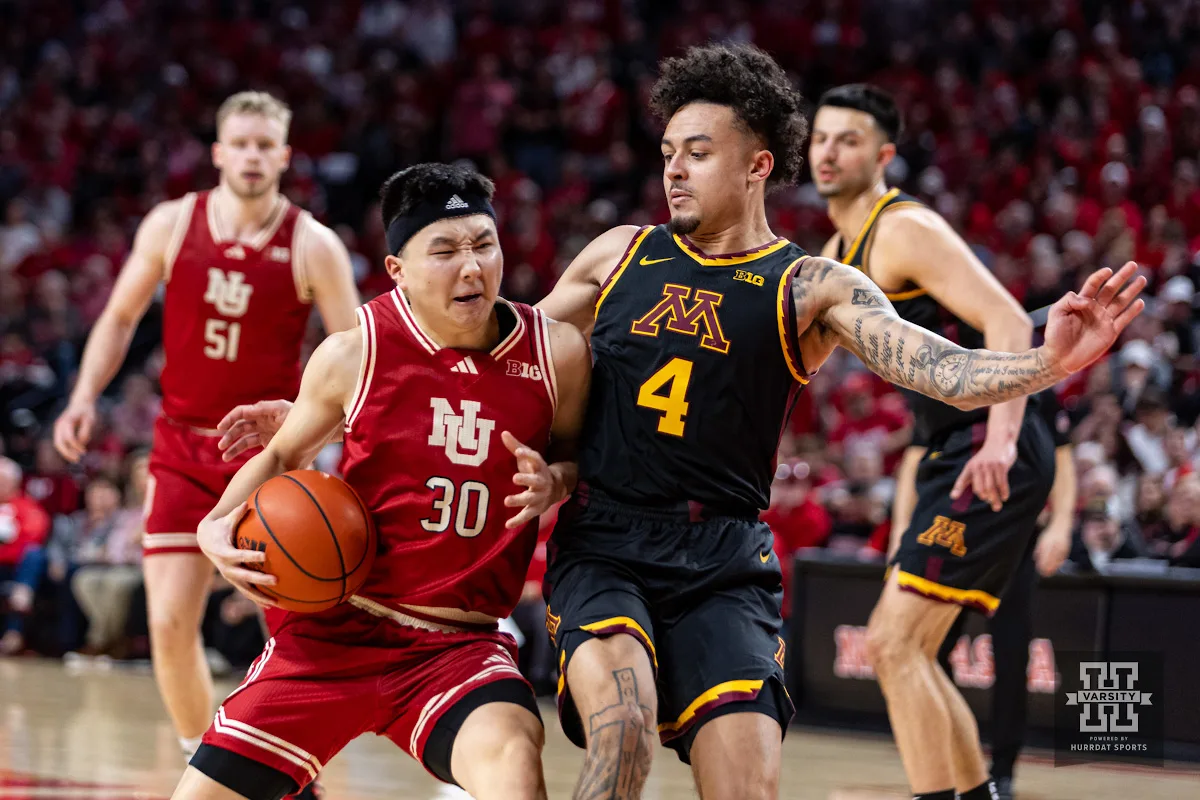 Nebraska Cornhusker guard Keisei Tominaga (30) drives into Minnesota Golden Gopher guard Braeden Carrington (4) in the second half during a college basketball game Sunday, February 25, 2024, in Lincoln, Neb. Photo by John S. Peterson.