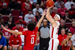 Nebraska Cornhusker guard Keisei Tominaga (30) makes a three point shot against Rutgers Scarlet Knight guard Derek Simpson (0) in the first half during a college basketball game Sunday, March 3, 2024, in Lincoln, Neb. Photo by John S. Peterson.