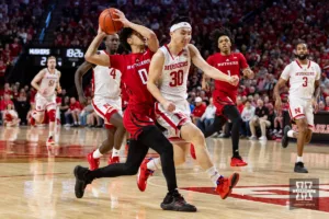 Nebraska Cornhusker guard Keisei Tominaga (30) tries to slow down Rutgers Scarlet Knight guard Derek Simpson (0) trying for a lay up in the first quarter during a college basketball game Sunday, March 3, 2024, in Lincoln, Neb. Photo by John S. Peterson.