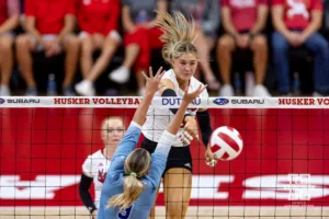 Nebraska Cornhusker Andi Jackson (15) spikes the ball against Texas A&M CC Islander Kyndal Payne (9) during the college volleyball game Friday, August 30, 2024, in Lincoln, Nebraska. Photo John S. Peterson.