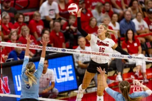 Nebraska Cornhusker Andi Jackson (15) spikes the ball against Texas A&M CC Islander Kyndal Payne (9) during the college volleyball game Friday, August 30, 2024, in Lincoln, Nebraska. Photo John S. Peterson.