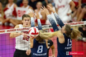 Nebraska Cornhusker outside hitter Lindsay Krause (22) spikes the ball against Creighton Bluejay outside hitter Ava Martin (8) and setter Kendra Wait (15) in the second set during the college volleyball match Tuesday, September 10, 2024, in Lincoln, Nebraska. Photo John S. Peterson.8