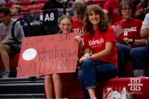 Nebraska Cornhusker fans showing up early to watch warm-ups and showing off their sign during a college volleyball match against the Purdue Boilermakers Friday, October 11, 2024, in Lincoln, Nebraska. Photo by John S. Peterson.