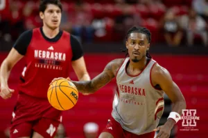 Nebraska Cornhusker Ahron Ulis (gray) dribbles the ball down the court during a scrimmage Sunday, October 13, 2024, in Lincoln, Nebraska. Photo by John S. Peterson.