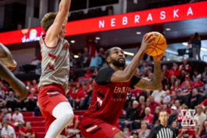 Nebraska Cornhusker Brice Williams (red) makes a lay up against Connor Essegian (gray) during a scrimmage Sunday, October 13, 2024, in Lincoln, Nebraska. Photo by John S. Peterson.