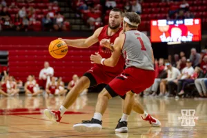 Nebraska Cornhusker Rollie Worster (red) dribbles the ball against Sam Hoiberg (1) during a scrimmage Sunday, October 13, 2024, in Lincoln, Nebraska. Photo by John S. Peterson.