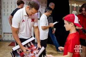 Nebraska Cornhusker head coach Fred Hoiberg signs a poster for a young fan after the scrimmage Sunday, October 13, 2024, in Lincoln, Nebraska. Photo by John S. Peterson.