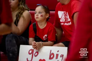 Nebraska Cornhusker fan watching warm-ups before the match against the Rutgers Scarlet Knights during a college volleyball match Saturday, October 12, 2024, in Lincoln, Nebraska. Photo by John S. Peterson.