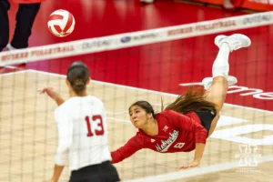 Nebraska Cornhusker Lexi Rodriguez (8) makes a diving save against the Purdue Boilermakers during a college volleyball match Friday, October 11, 2024, in Lincoln, Nebraska. Photo by John S. Peterson.