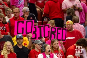 Nebraska Cornhusker fans swtich their regular signs for pink ones during a college volleyball match against the Rutgers Scarlet Knights Saturday, October 12, 2024, in Lincoln, Nebraska. Photo by John S. Peterson.