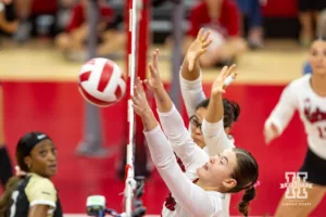 Nebraska Cornhusker Lindsay Krause (22) reaches to block a shot against the Purdue Boilermakers during a college volleyball match Friday, October 11, 2024, in Lincoln, Nebraska. Photo by John S. Peterson.