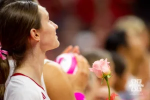 Nebraska Cornhusker Bergen Reilly (2) holds a rose for the breast cancer awareness match against the Rutgers Scarlet Knights during a college volleyball match Saturday, October 12, 2024, in Lincoln, Nebraska. Photo by John S. Peterson.