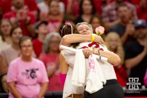 Nebraska Cornhusker Lindsay Krause (22) presents a rose to her mom Joanna Drapper a breast cancer survivor before the match against the Rutgers Scarlet Knights during a college volleyball match Saturday, October 12, 2024, in Lincoln, Nebraska. Photo by John S. Peterson.