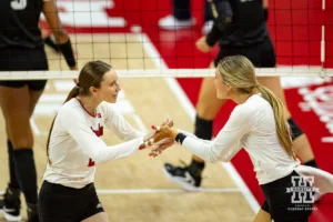 Nebraska Cornhusker Bergen Reilly (2) and Andi Jackson celebrate a point against the Purdue Boilermakers during a college volleyball match Friday, October 11, 2024, in Lincoln, Nebraska. Photo by John S. Peterson.