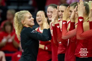 Nebraskan and Rutgers Scarlet Knight libero Kenzie Dyrstad (3) gives high fives to her teammates when introduced before taking on the Huskers during a college volleyball match Saturday, October 12, 2024, in Lincoln, Nebraska. Photo by John S. Peterson.