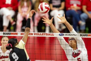 Nebraska Cornhusker Rebekah Allick (5) jumps to block a shot from Purdue Boilermaker middle blocker Lourdès Myers (9) during a college volleyball match Friday, October 11, 2024, in Lincoln, Nebraska. Photo by John S. Peterson.