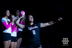 Nebraska Cornhusker Lexi Rodriguez (8) throws out a mini volleyball before taking on Rutgers Scarlet Knights during a college volleyball match Saturday, October 12, 2024, in Lincoln, Nebraska. Photo by John S. Peterson.