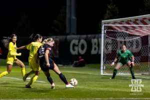 Nebraska Cornhusker forward Sarah Weber (42) takes a shot against Oregon Duck defender Mia McSweeney (8) in the first half during a soccer match Thursday, October 17, 2024, in Lincoln, Nebraska. Photo by John S. Peterson.