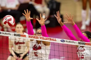 Nebraska Cornhusker Rebekah Allick (5) and Taylor Landfair jump to block a shot from the Rutgers Scarlet Knights during a college volleyball match Saturday, October 12, 2024, in Lincoln, Nebraska. Photo by John S. Peterson.