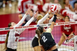 Nebraska Cornhusker Andi Jackson (15) blocks a shot from Purdue Boilermaker outside hitter Chloe Chicoine (2) during a college volleyball match Friday, October 11, 2024, in Lincoln, Nebraska. Photo by John S. Peterson.