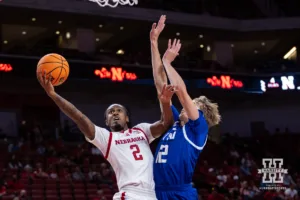 Nebraska Cornhusker Ahron Ulis (2) makes a lay up against Grand Valley State Laker Cam Regnerus (12) during a college men’s basketball game Thursday, October 27, 2024, in Lincoln, Nebraska. Photo by John S. Peterson.