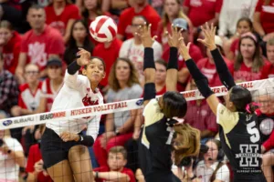 Nebraska Cornhusker Taylor Landfair (12)spikes the ball against the Purdue Boilermakers during a college volleyball match Friday, October 11, 2024, in Lincoln, Nebraska. Photo by John S. Peterson.