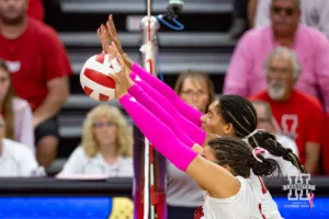 Nebraska Cornhusker Rebekah Allick (5) and Taylor Landfair block a shot from the Rutgers Scarlet Knights during a college volleyball match Saturday, October 12, 2024, in Lincoln, Nebraska. Photo by John S. Peterson.