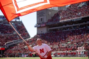 Nebraska Cornhusker cheer squad member waves the flag after the touchdown against the Ohio State Buckeyes during a college football game Saturday, October 26, 2024, in Lincoln, Nebraska. Photo by John S. Peterson.