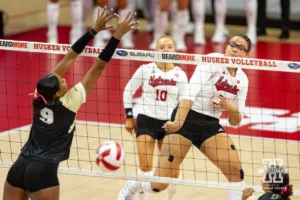 Nebraska Cornhusker Rebekah Allick (5) spike the ball past Purdue Boilermaker middle blocker Lourdès Myers (9) during a college volleyball match Friday, October 11, 2024, in Lincoln, Nebraska. Photo by John S. Peterson.