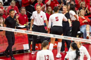 Nebraska Cornhusker head coach John Cook gives Rebekah Allic five coming off the court during a college volleyball match Friday, October 11, 2024, in Lincoln, Nebraska. Photo by John S. Peterson.