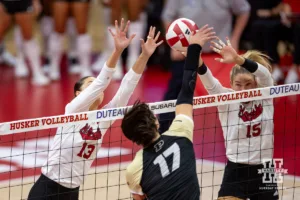 Nebraska Cornhusker Merritt Beason (13) and nu15#2 during a college volleyball match Friday, October 11, 2024, in Lincoln, Nebraska. Photo by John S. Peterson.