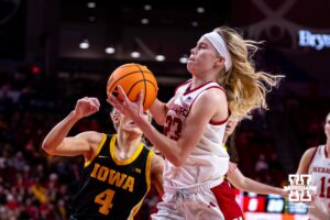 Nebraska Cornhusker guard Britt Prince (23) drives to the basket against Iowa Hawkeye guard Kylie Feuerbach (4) in the first quarter during a college basketball game on Monday, Feb. 16, 2026, in Lincoln, Nebraska. Photo by John S. Peterson.
